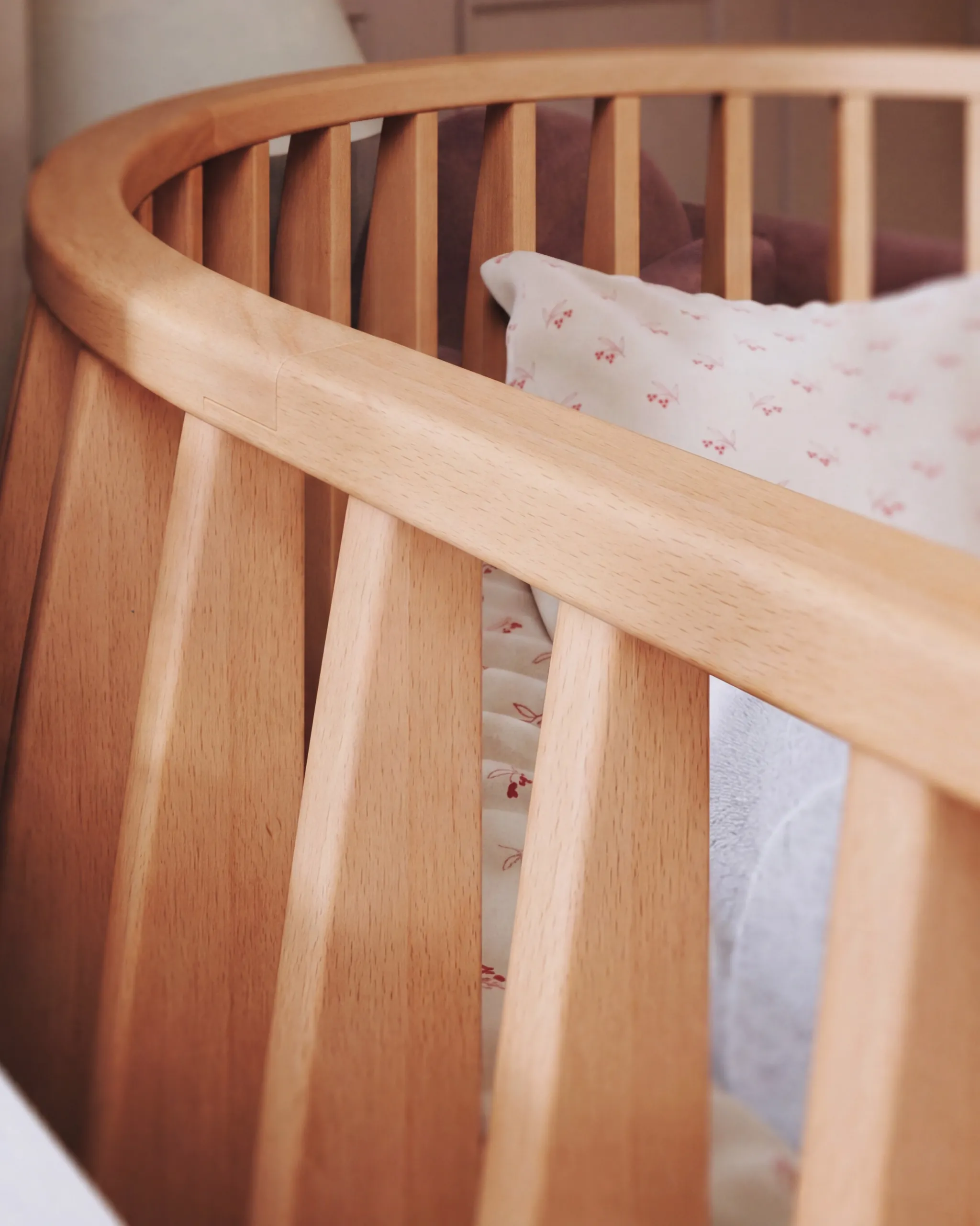 Curved rail detail of a beech Olga crib